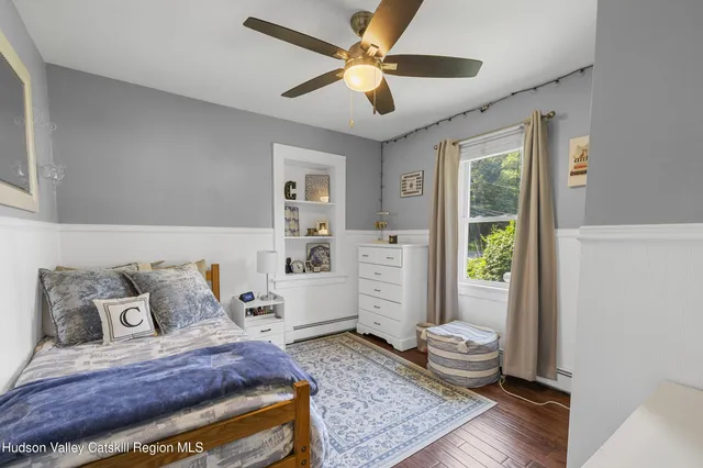a bedroom with furniture and a window