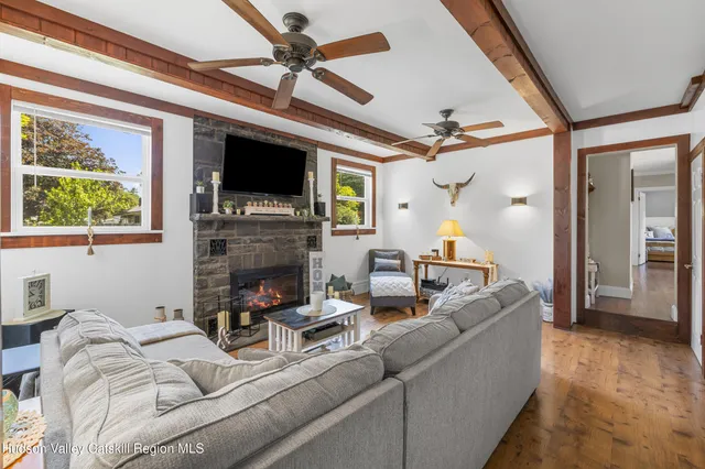 a living room with furniture a flat screen tv and a fireplace