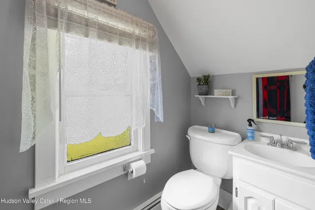 a white toilet sitting next to a bathroom sink