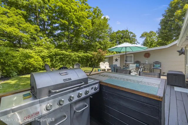 a view of a patio with table and chairs under an umbrella