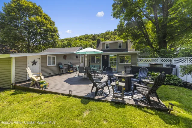 a view of a patio with table and chairs under an umbrella