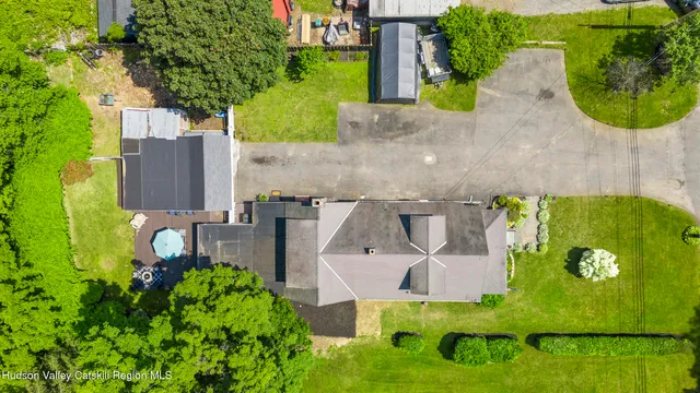 an aerial view of a house with garden space and street view