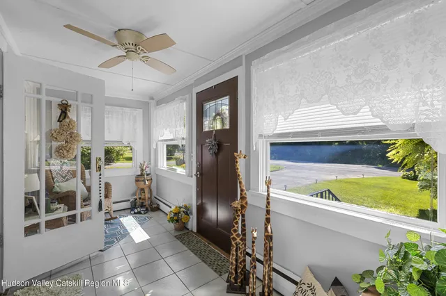 a view of hallway with livingroom and furniture