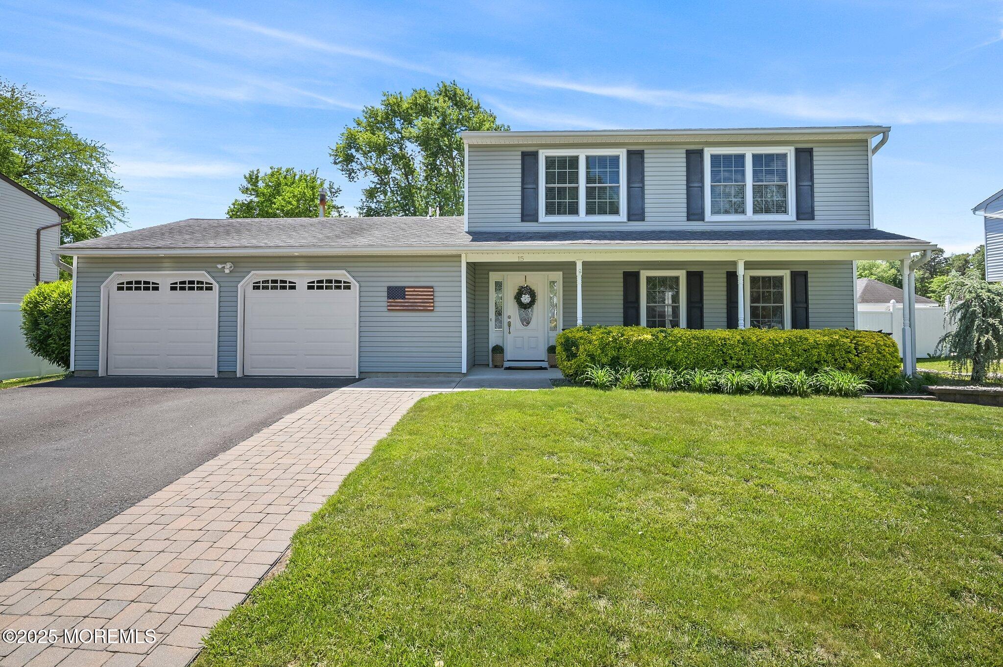 15 Peachstone Road Howell, NJ 07731 - Photo 1 of 2 a front view of a house with a garden and yard