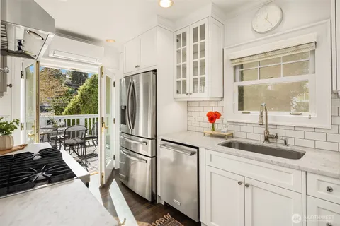 a kitchen with stainless steel appliances a sink stove and a refrigerator