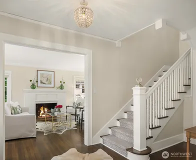 a view of a livingroom with wooden floor and a fireplace