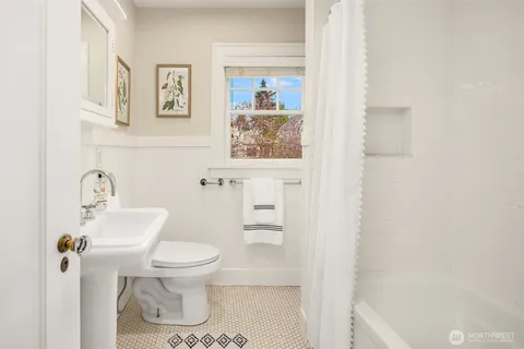 a bathroom with a toilet and a shower curtain