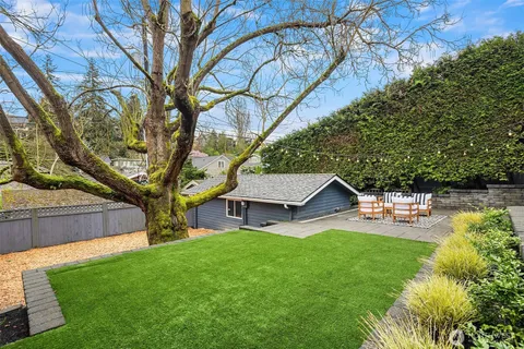 a view of a house with a yard and sitting area