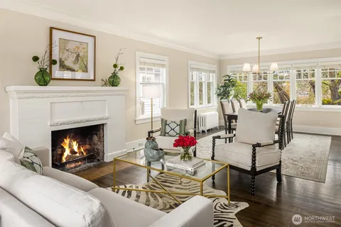 a living room with furniture a window and a fireplace