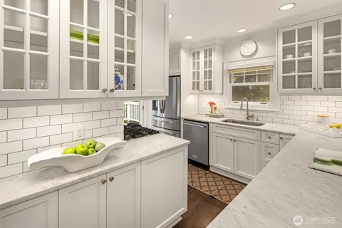 a kitchen with a sink stove and window