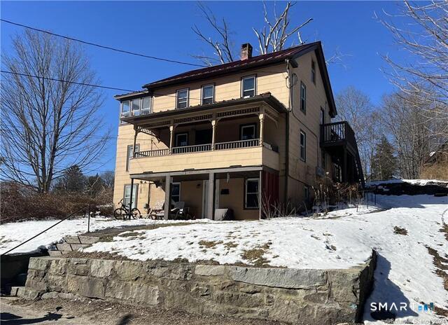 139 North Main Street, Unit 2 Winchester, CT 06098 - Photo 1 of 1 a view of a house with snow on the wall