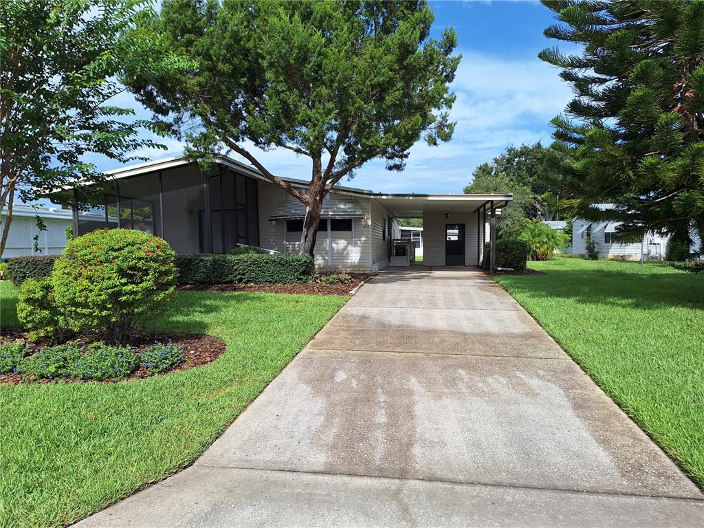 432 Santa Fe Road Tavares, FL 32778 - Photo 2 of 41 a front view of house with yard and green space