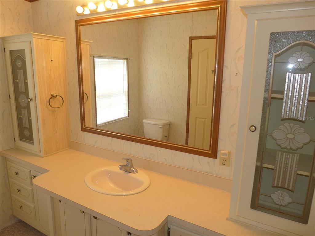 432 Santa Fe Road Tavares, FL 32778 - Photo 22 of 41 a bathroom with a sink and a mirror