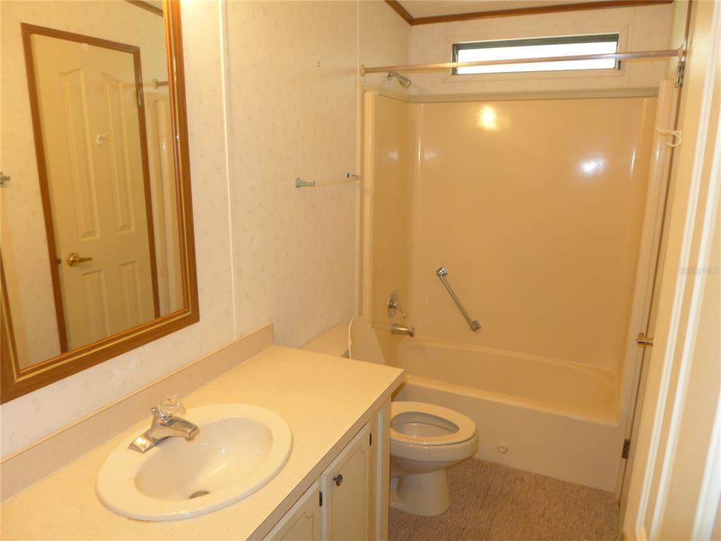 432 Santa Fe Road Tavares, FL 32778 - Photo 27 of 41 a bathroom with a sink a toilet and shower