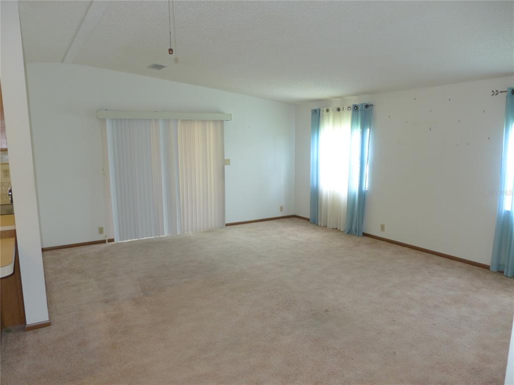 432 Santa Fe Road Tavares, FL 32778 - Photo 3 of 41 an empty room with windows and closet