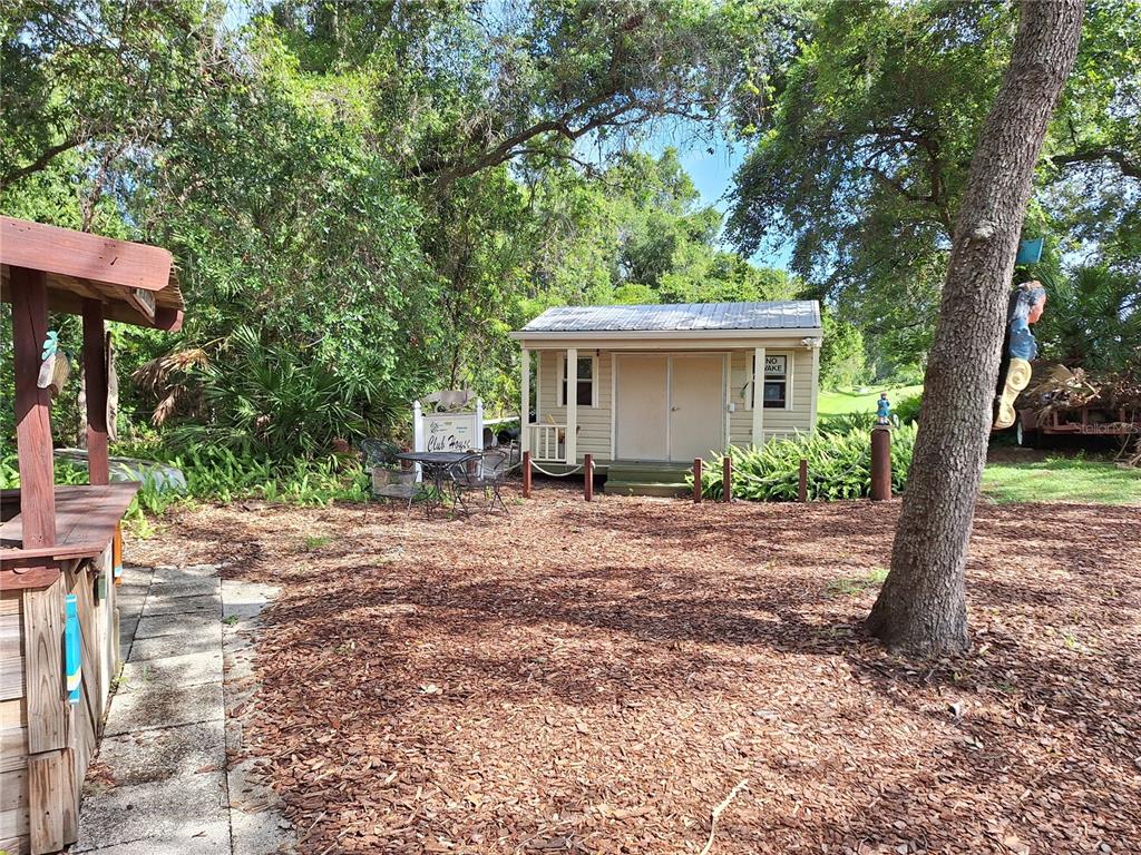 432 Santa Fe Road Tavares, FL 32778 - Photo 37 of 41 a view of a house with a tree in the background