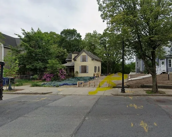 a view of a house with swimming pool and sitting area