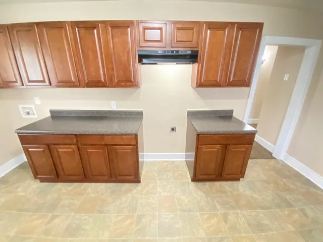 a kitchen with granite countertop cabinets and sink