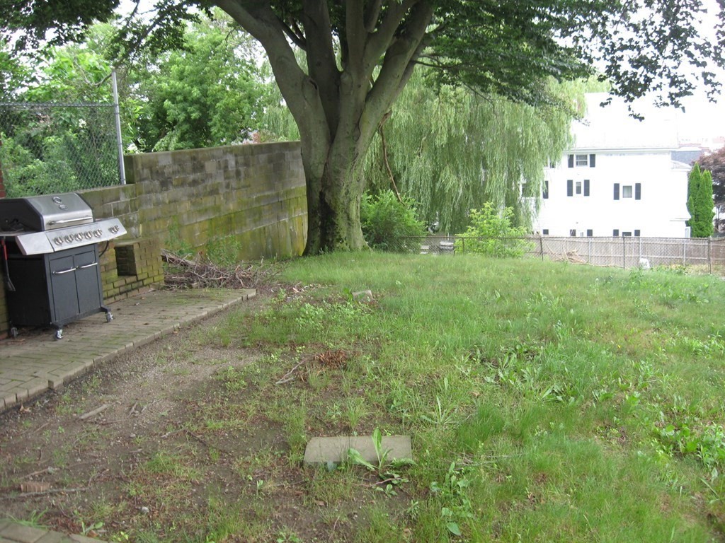 607 South Main Street Fall River, MA 02721 - Photo 3 of 24 a backyard of a house with lots of green space