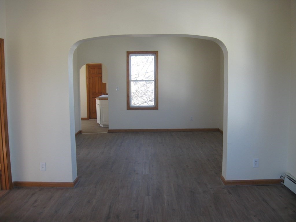 607 South Main Street Fall River, MA 02721 - Photo 8 of 24 an empty room with wooden floor and windows