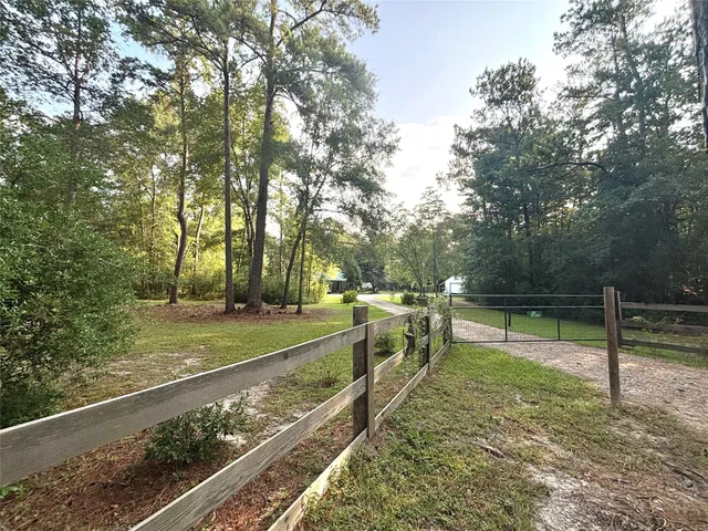 a view of a backyard with wooden fence