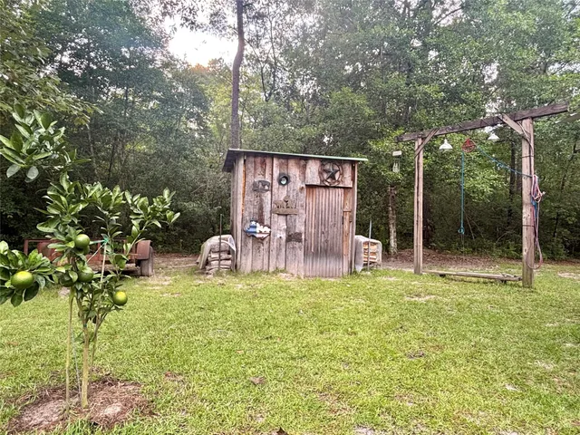 a view of a two chairs in a backyard
