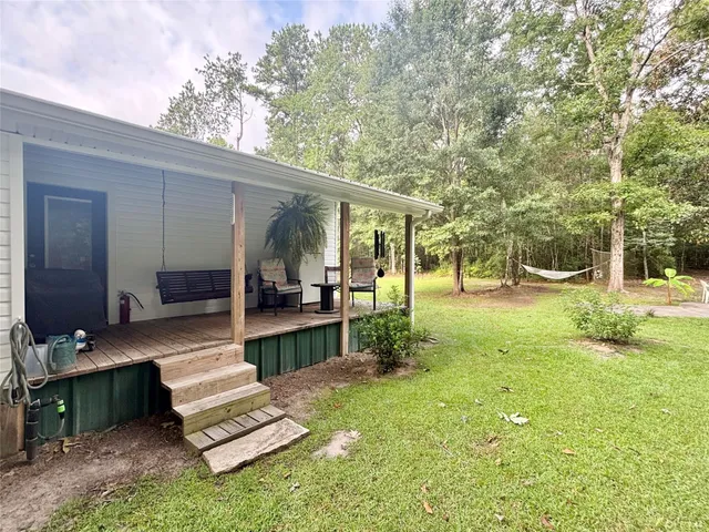 a view of a patio with couches and a table and chairs with garden view