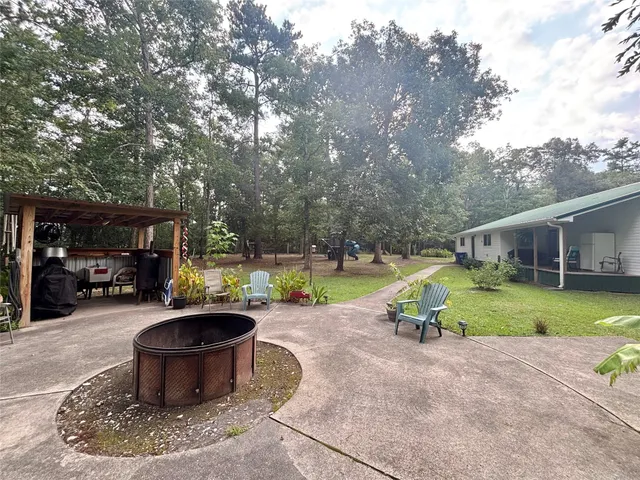 a view of a backyard with table and chairs