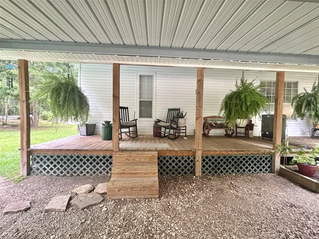 a outdoor space with lots of furniture and white walls