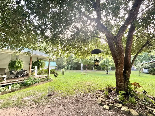a front view of a house with a yard and trees