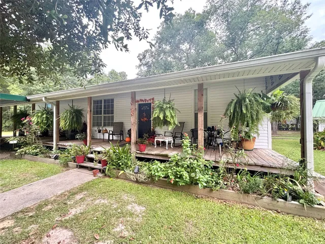 a view of a backyard with plants and patio