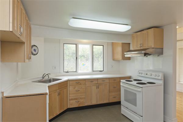 57 Concord Road Wayland, MA 01778 - Photo 3 of 10 a kitchen with cabinets appliances a sink and a window