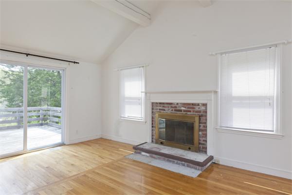 57 Concord Road Wayland, MA 01778 - Photo 5 of 10 a view of an empty room with a fireplace and a window