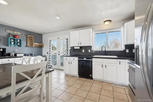 a kitchen with a sink cabinets and stainless steel appliances