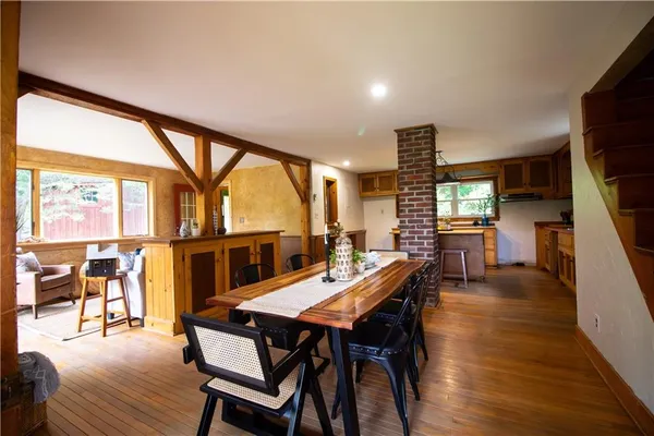 a view of a dining room with furniture window and wooden floor