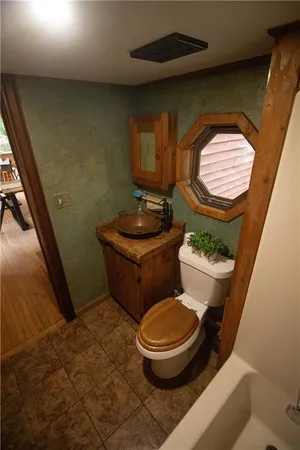 a bathroom with a toilet and a mirror