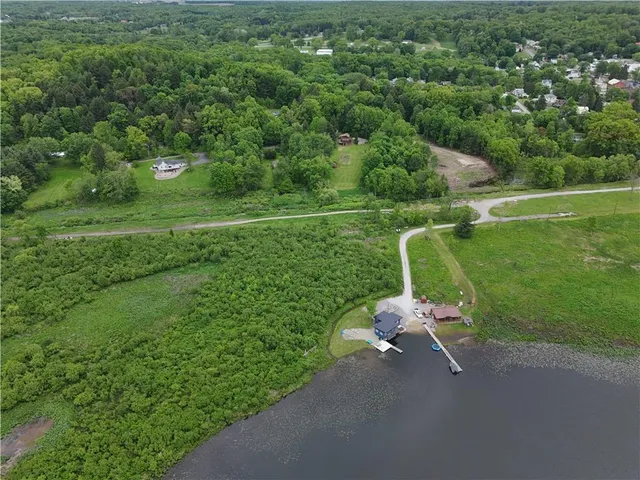 a backyard of a house with a yard and outdoor seating