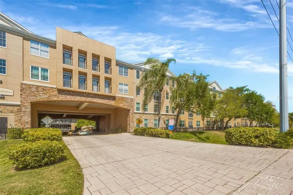 a front view of a building with a garden