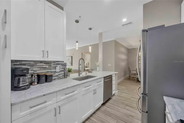 a kitchen with stainless steel appliances a sink stove and cabinets