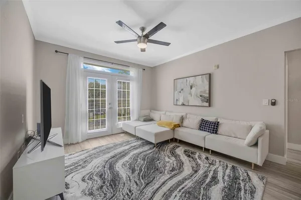 a spacious bedroom with a bed furniture and a flat screen tv