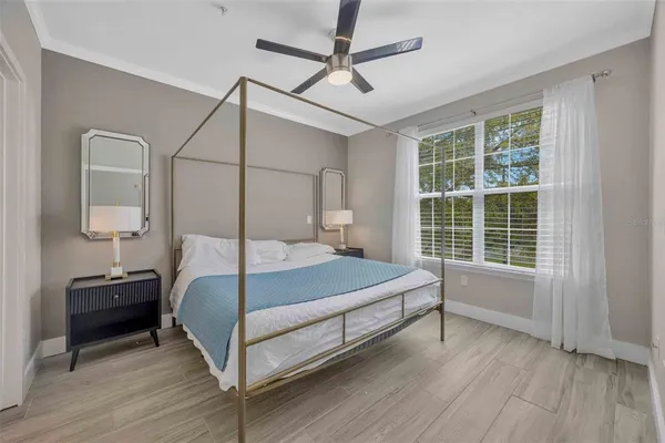 a bedroom with a bed and a window