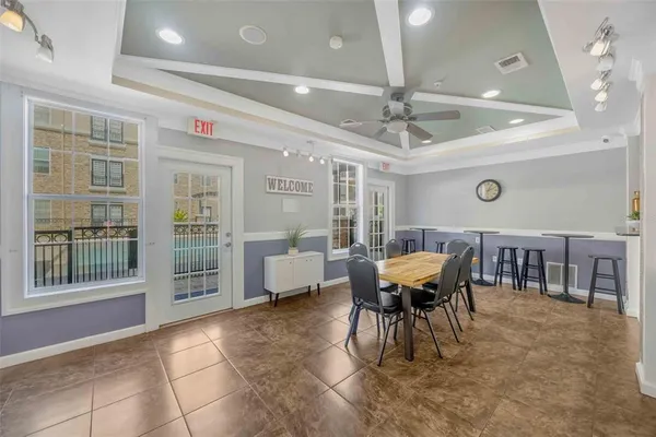 a view of a dining room with furniture and chandelier
