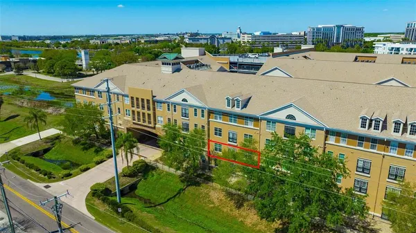 an aerial view of a house with a yard and lake view