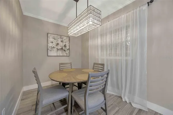 a view of a dining room with furniture and a chandelier