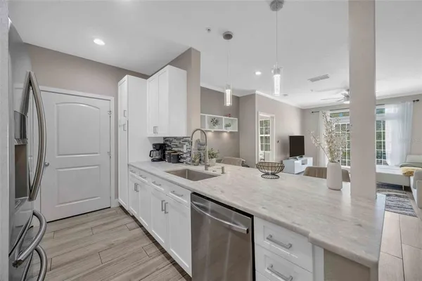 a kitchen with sink refrigerator and cabinets