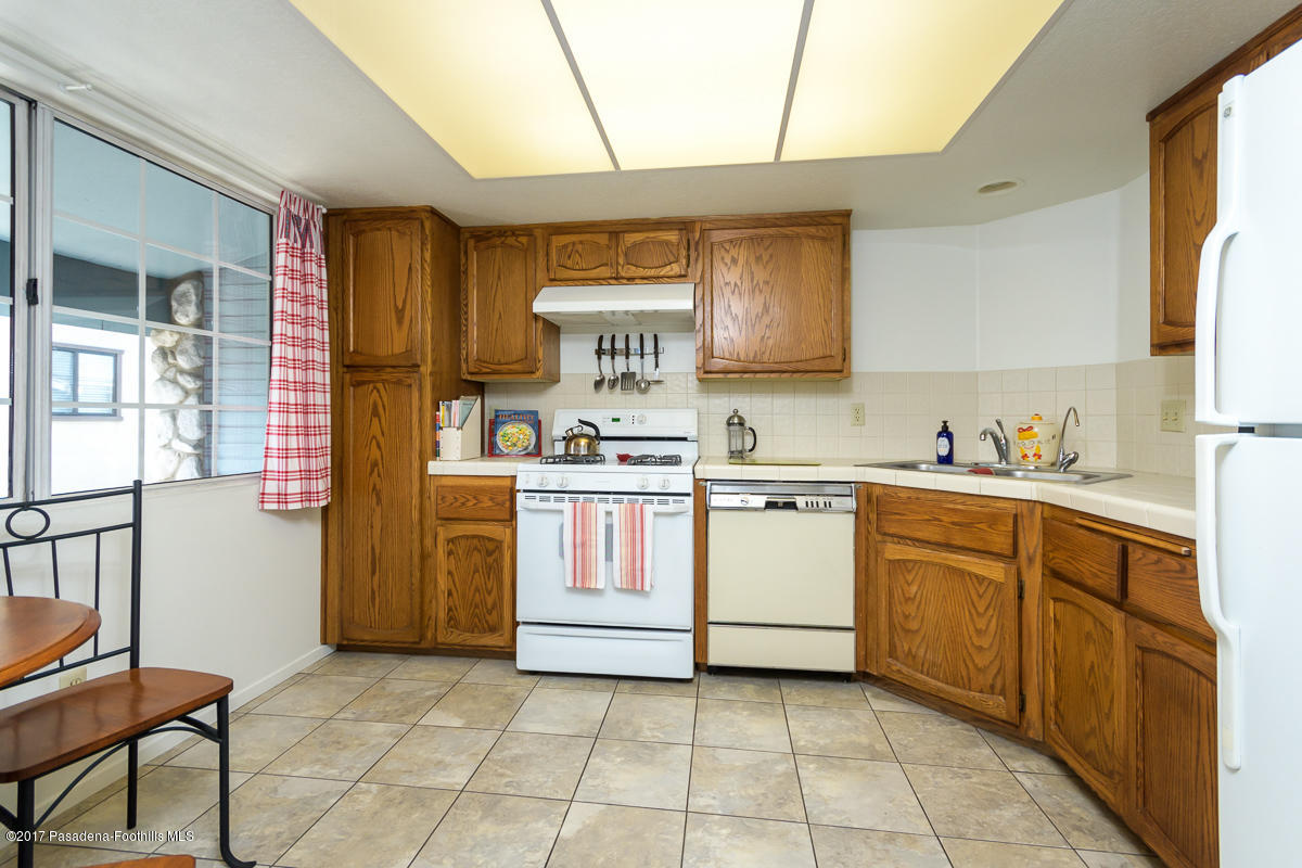 2248 Del Mar Road, Unit 7 Montrose, CA 91020 - Photo 12 of 35 a kitchen with a stove window and cabinets