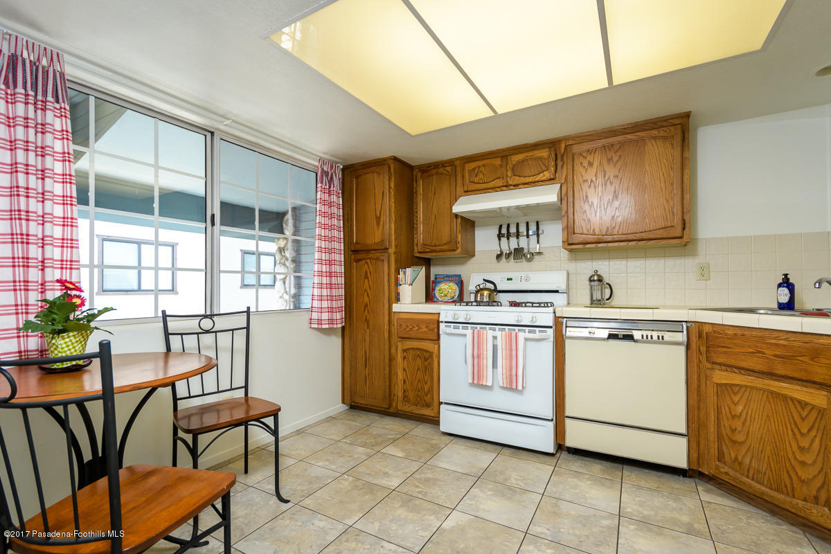 2248 Del Mar Road, Unit 7 Montrose, CA 91020 - Photo 13 of 35 a kitchen with a stove window and chairs