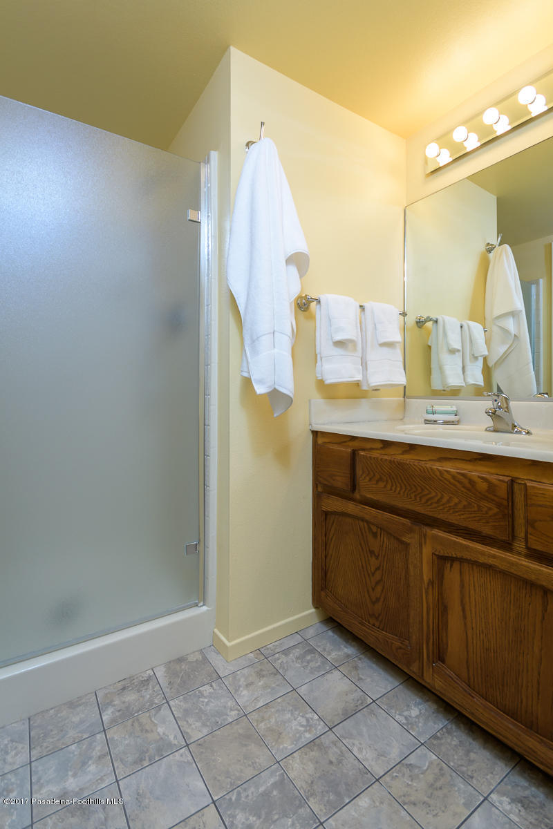2248 Del Mar Road, Unit 7 Montrose, CA 91020 - Photo 24 of 35 a bathroom with a granite countertop sink a mirror and a shower