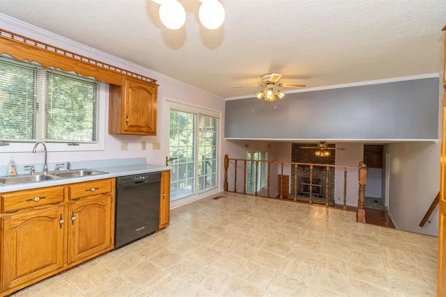 a view of a kitchen with a sink and cabinets