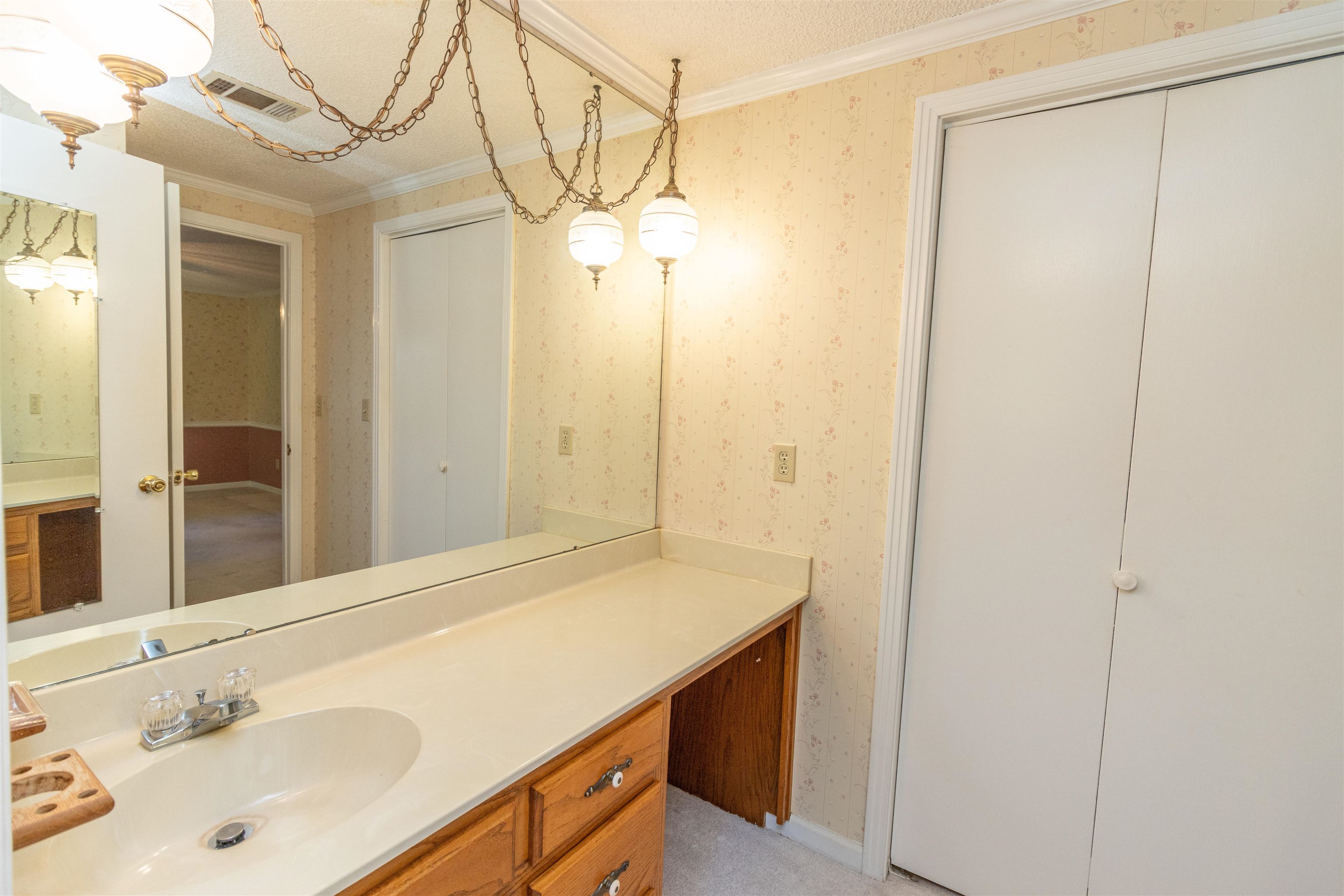 651 Pine Street Adamsville, TN 38310 - Photo 16 of 25 a bathroom with a sink and a mirror